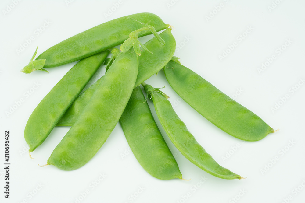 Fresh harvested Snow pea (Pisum sativum var. saccharatum) also known as mangetout organical grown in my garden isolated on white background Fresh harvested Snow pea (Pisum sativum var. saccharatum) also known as mangetout organical grown in my garden isolated on white background