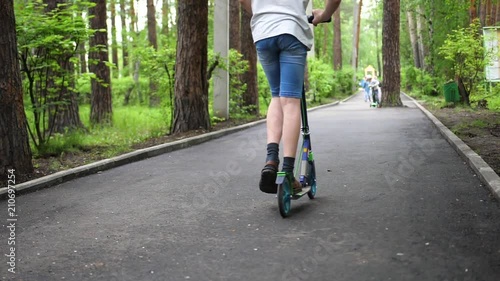 Wallpaper Mural The guy rides a scooter in the Park in early spring. Melting snow, snow and puddles on asphalt. Outdoor sports. Closeup Torontodigital.ca