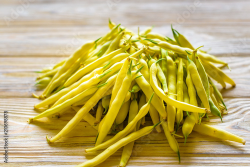 yellow beans on a wooden background.