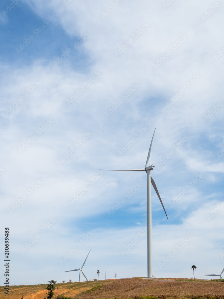 Landscape Wind turbines generating electricity with blue sky and mountain Landscape Wind turbines generating electricity with blue sky and mountain