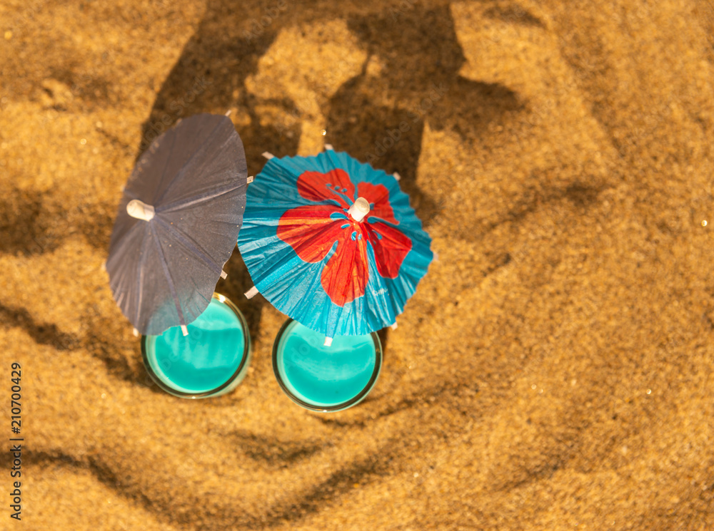 colorful shots drinks on a sandy beach with umbrellas for drinks colorful shots drinks on a sandy beach with umbrellas for drinks