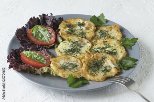 Roasted (fried) slices zucchini in egg batter photo