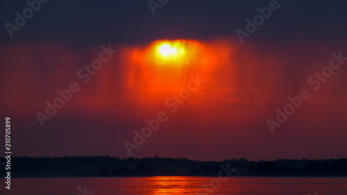Red sunset and dark rainy c...