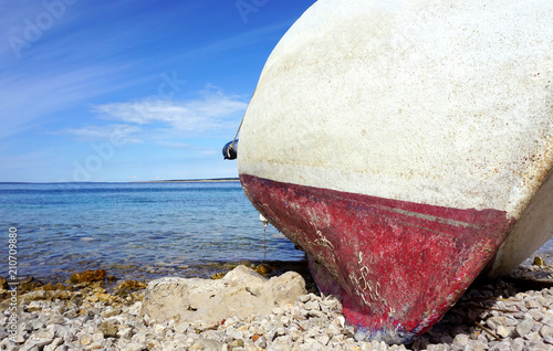 Close up view of old boat sunk on the pebble beach in Adriatic sea