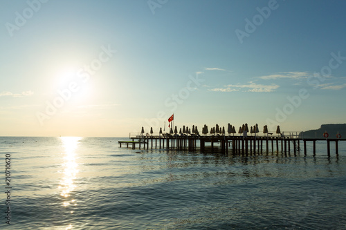 Pier with flag at sunrise in Kemer