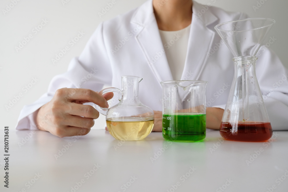 doctor woman scientist making herbal medicine in lab with herb leaves vitamin supplements mineral alternative treatment research. doctor woman scientist making herbal medicine in lab with herb leaves vitamin supplements mineral alternative treatment research.