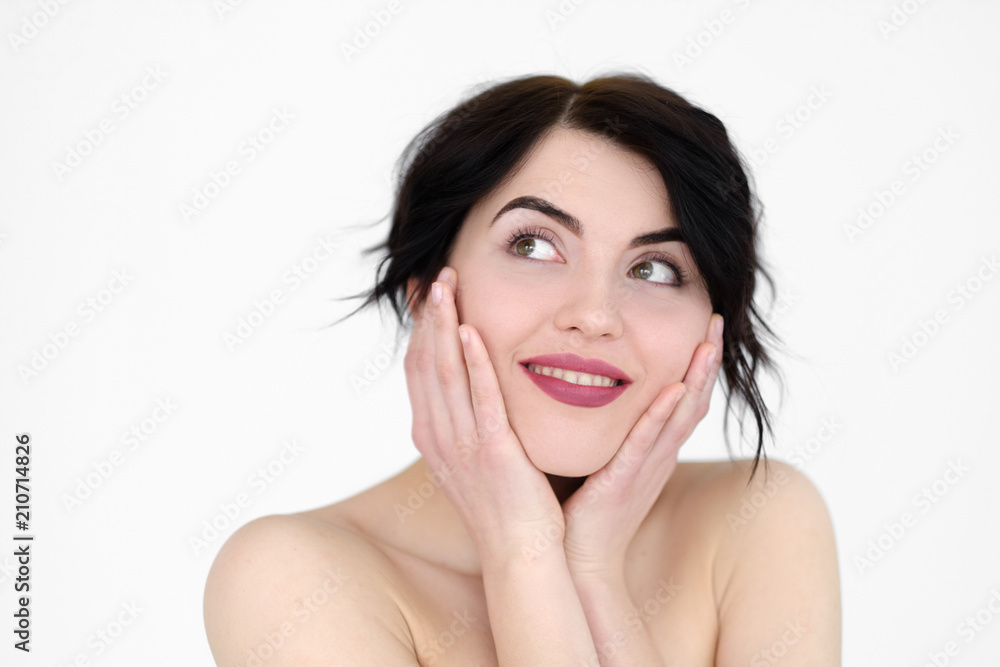 emotion face. happy smiling joyful jolly woman holding head in hands. young beautiful brunette girl portrait on white background.