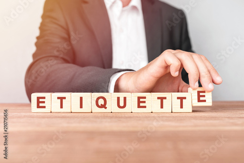 Man made word ETIQUETTE with wood blocks