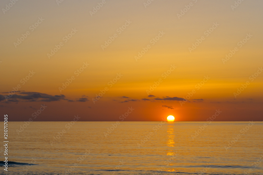 Mallorca, Golden hour sunrise magic moment with sun reflections on water, early morning at beach