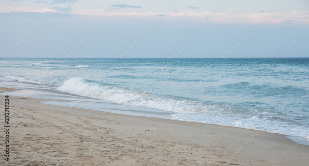 The waves crashing ashore on the beach at dusk on the east coast. The waves crashing ashore on the beach at dusk on the east coast.