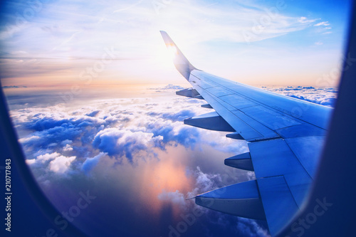 flying and traveling, view from airplane window on the wing on sunset time photo