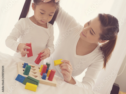 preschool age little Asia children play with colorful plastic toy blocks.Child playing with building blocks learning new skills.