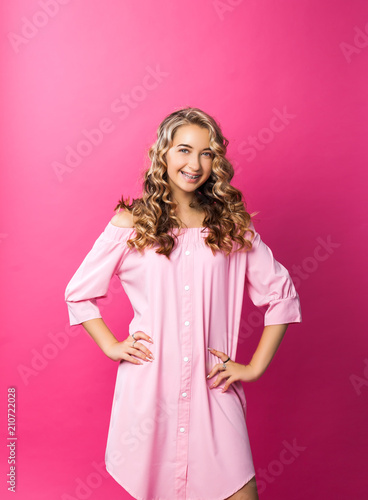 Pretty stylish Beautiful girl wearing pink dress posing