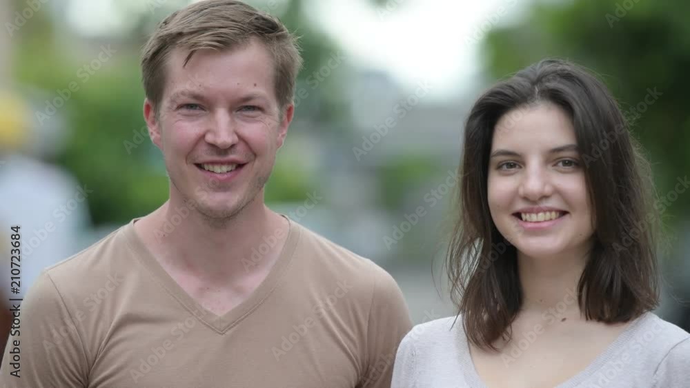 Young happy couple together in the streets outdoors Young happy couple together in the streets outdoors