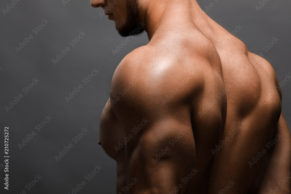 Young handsome muscular man bodybuilder posing in the studio Young handsome muscular man bodybuilder posing in the studio