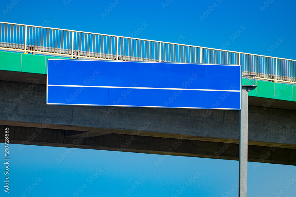 Big blank highway road sign with gradient blue sky Big blank highway road sign with gradient blue sky