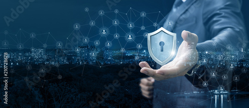 Fotografia, Obraz Businessman showing a shield of protection network.