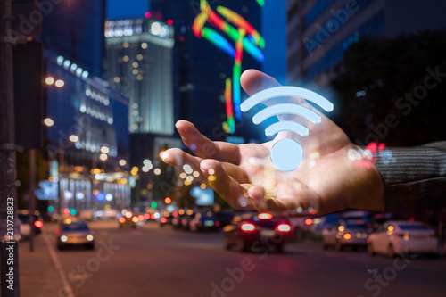 Hand with the sign of the Wifi zone .