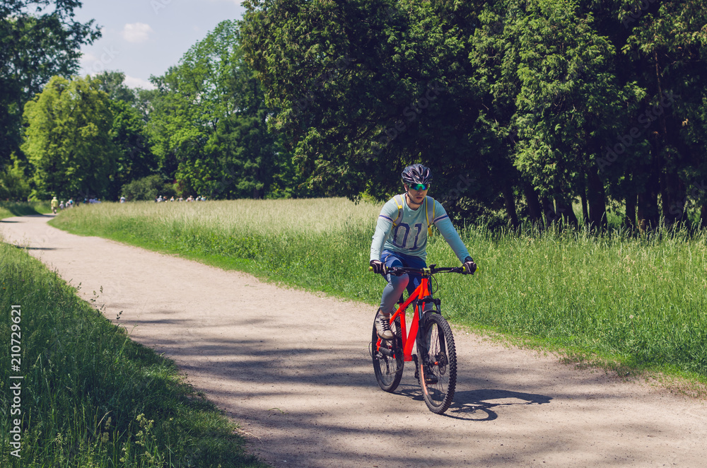 The cyclist in motion riding bicycle road The cyclist in motion riding bicycle road