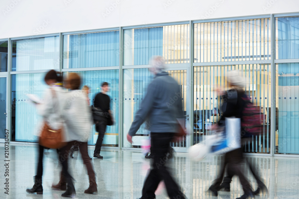 Group of Businesspeople Walking in New Office Building, Motion Blur Group of Businesspeople Walking in New Office Building, Motion Blur