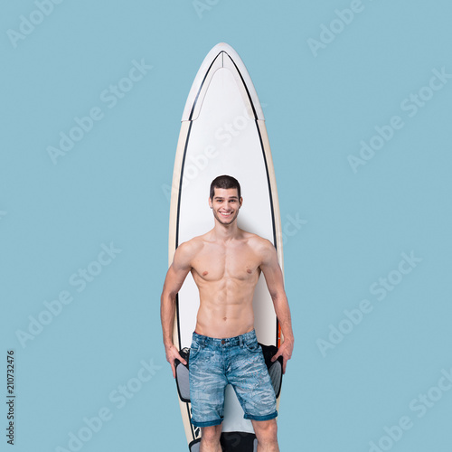 Attractive surfer holding a surfboard