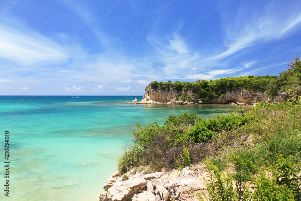 Seascape view rocky shoreline with azure calm ocean and bright blue sky location at Macao beach in tropical island Dominican republic. Seascape view rocky shoreline with azure calm ocean and bright blue sky location at Macao beach in tropical island Dominican republic.