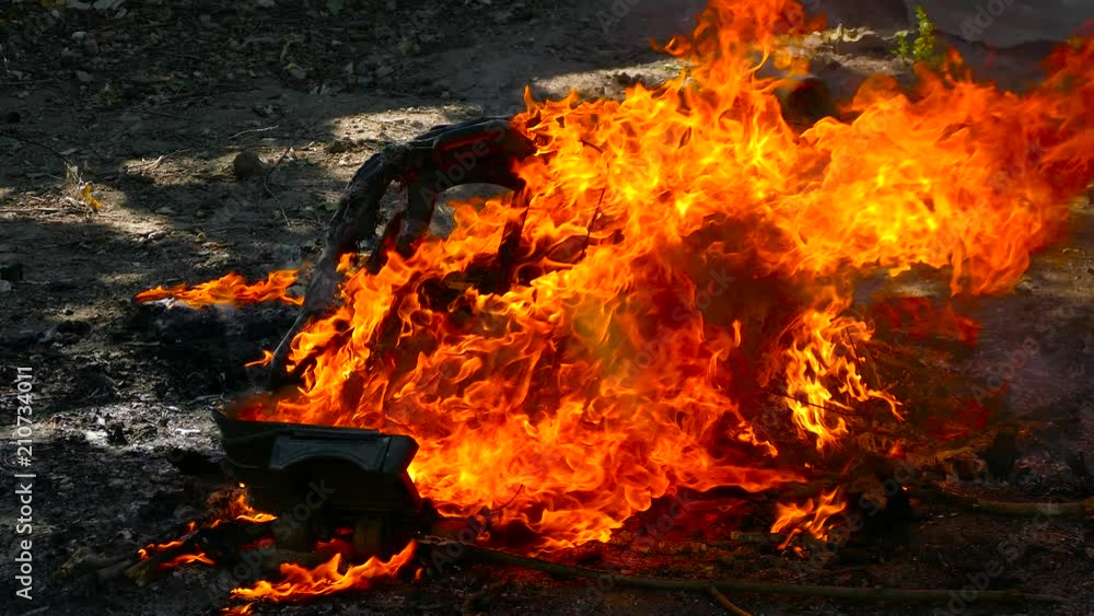 in bright fire burns plastic suitcase and smokes black smoke in bright fire burns plastic suitcase and smokes black smoke