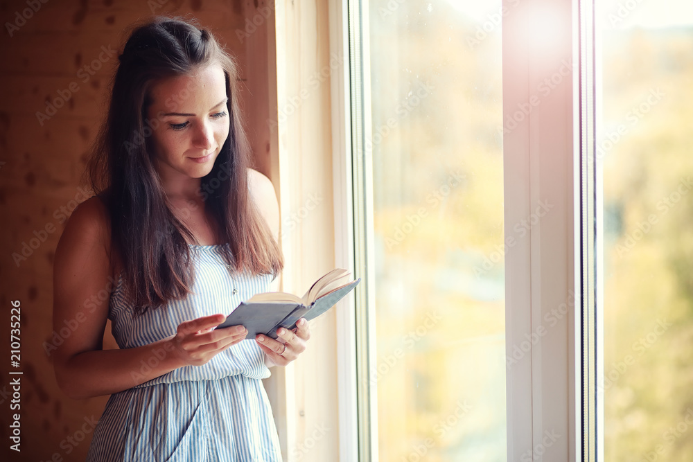 A girl at the window in the house A girl at the window in the house