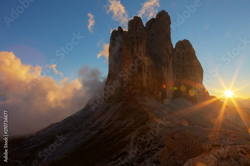 Fog, lit by the sun at sunset among the rocks Tre Cime di Lavaredo , Dolomites, Italy
