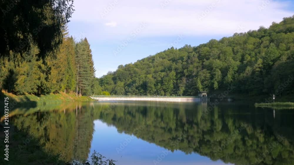 Lake of the dam in the pine forest in the mountains, Lago Ponte Vittorio, Camandona Lake of the dam in the pine forest in the mountains, Lago Ponte Vittorio, Camandona