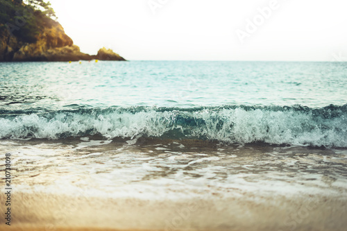 Fototapeta Naklejka Na Ścianę i Meble -  coastline beach on sunny day background of ocean and horizont sky, gold sand blur, tourism relax calm concept, seascape perspective vacation, summer seashore on blue sea waves and sand