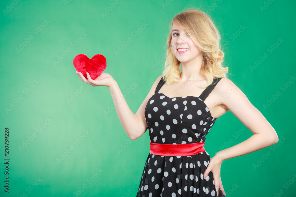 Woman holding red heart love symbol Woman holding red heart love symbol