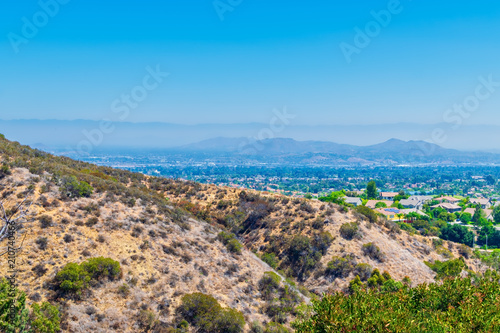 Layer of light smog covers Southern California houses with view from mountains