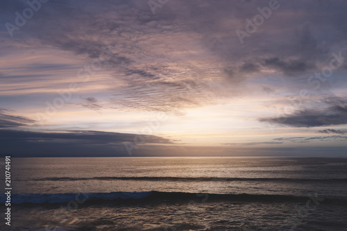 Sunlight sunset on horizon ocean on background seascape rays sunrise. Relax view waves sea on evening sand beach, sun light evening outdoor vacation concept, copy space for text.