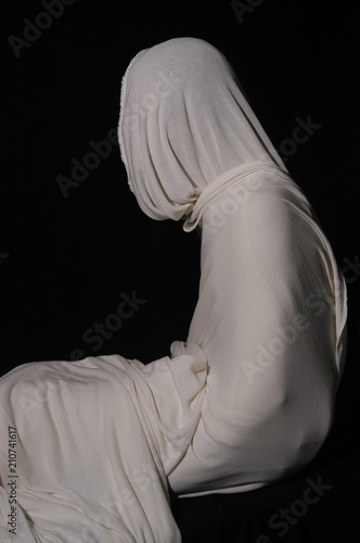 Lazarus, rising from the dead in the tomb. Studio shot of man wrapped in white cloth. Christ rising from tomb, resurrection concept for Easter and miracles of Jesus.