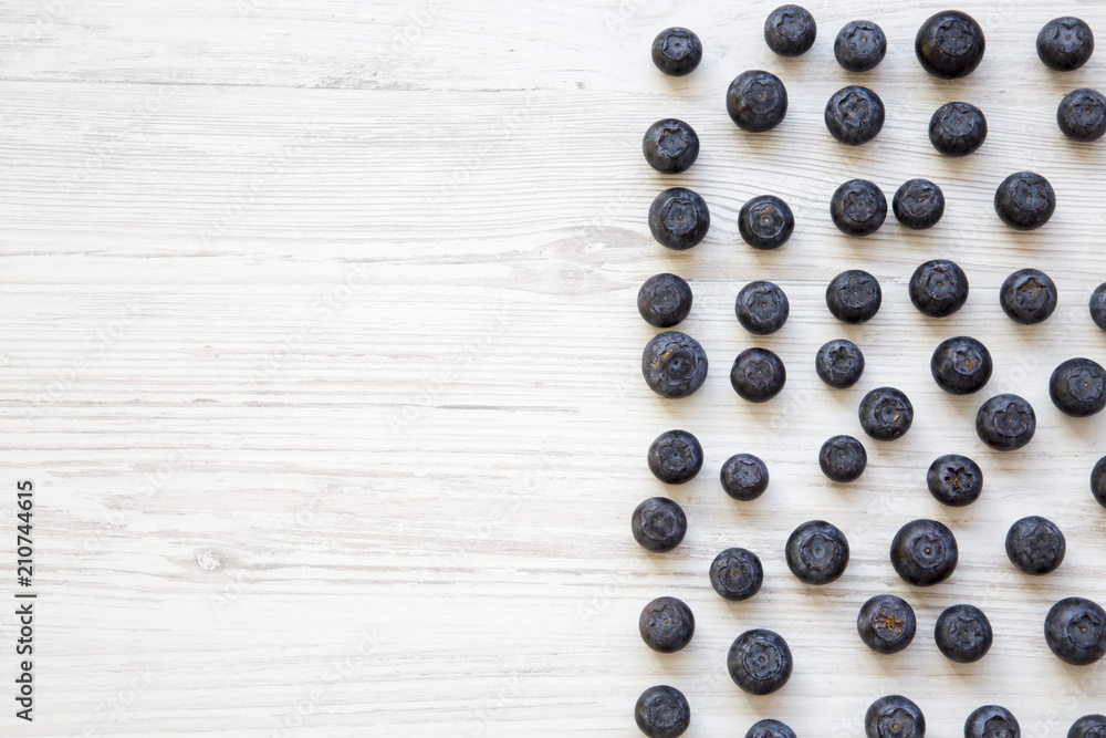 Blueberries on a white wooden background, top view. Copy space. Blueberries on a white wooden background, top view. Copy space.