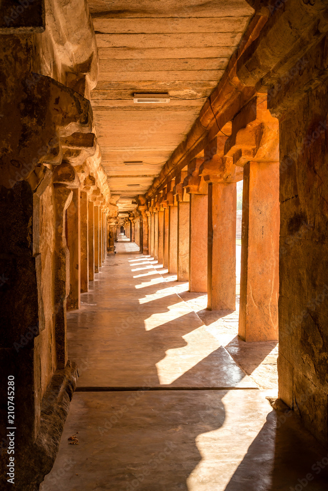 Beautiful view of hallway full of columns at an Indian ancient temple, Brihadeshwara temple, Thanjavur, Tamil Nadu, India Beautiful view of hallway full of columns at an Indian ancient temple, Brihadeshwara temple, Thanjavur, Tamil Nadu, India