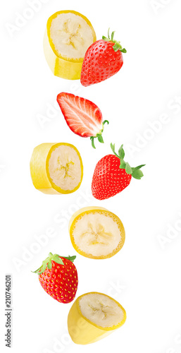 Falling banana and strawberry fruits isolated on white background