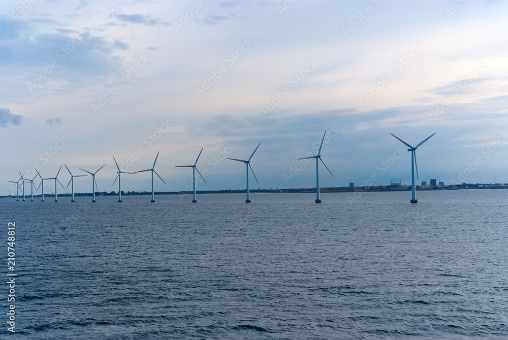 Wind turbines in sea in Copenhagen, Denmark. Offshore wind farm for renewable sustainable and alternative energy production. Green economy. Ecology and environment. Eco power