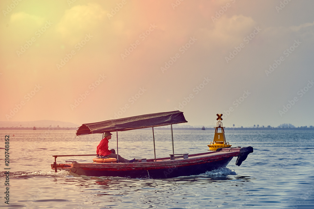 Fishing boat in Ha long Bay, Panoramic view of sunset in Halong Bay, Vietnam, Southeast Asia,UNESCO World Heritage Site Fishing boat in Ha long Bay, Panoramic view of sunset in Halong Bay, Vietnam, Southeast Asia,UNESCO World Heritage Site