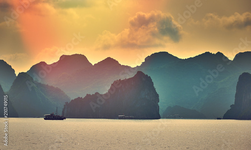 Halong bay boats,Sunset at Ha Long Bay scenic view , Hanoi, Vietnam , Southeast Asia photo