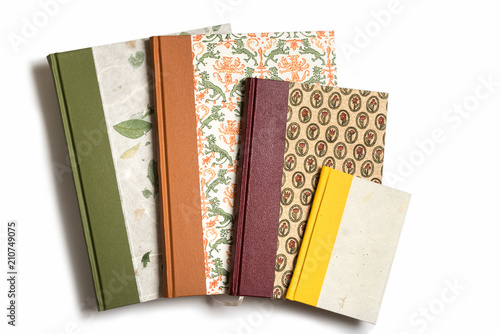 Four handmade, quarter bound books against a white background. photo