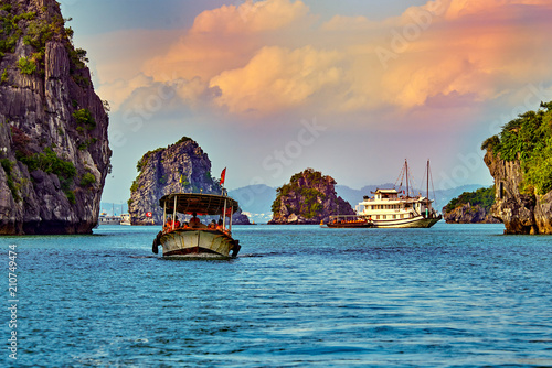 Ha Long Bay , Vietnam-29 November 2014:Tourist Junks in Halong Bay,Panoramic view of sunset in Halong Bay, Vietnam, Southeast Asia,UNESCO World Heritage Site
