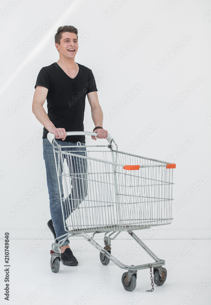 young man with a shopping cart steps forward young man with a shopping cart steps forward