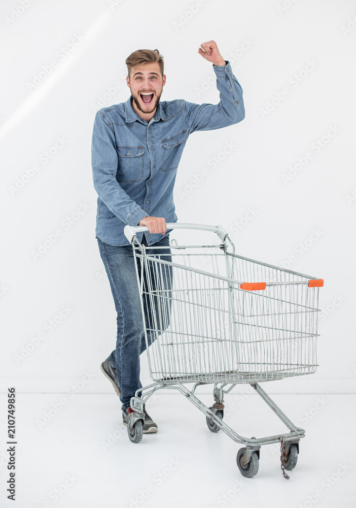 Full length portrait of a happy man running with a shopping trolley Stock  Photo | Adobe Stock