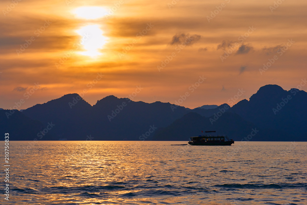 Tourist Junks in Halong Bay,Panoramic view of sunset in Halong Bay, Vietnam, Southeast Asia,UNESCO World Heritage Site