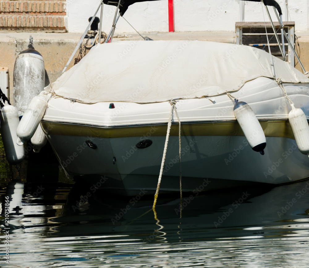 closeup on elements of yachts and motor boats anchored in the harbor, hot day at harbor