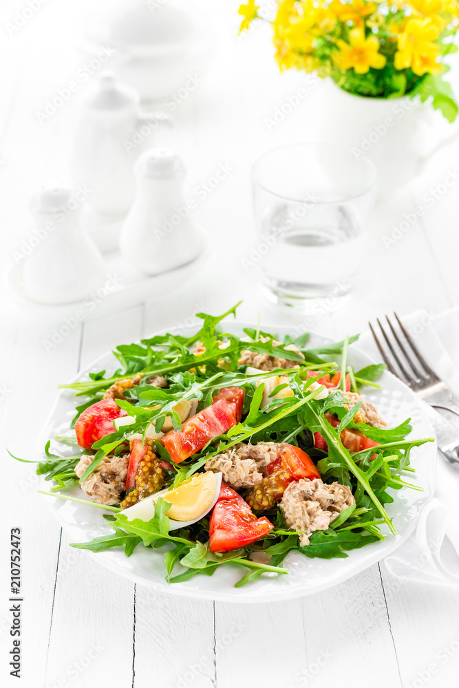 Salad with tuna. Vegetable salad with boiled egg, tuna and arugula. Fish salad