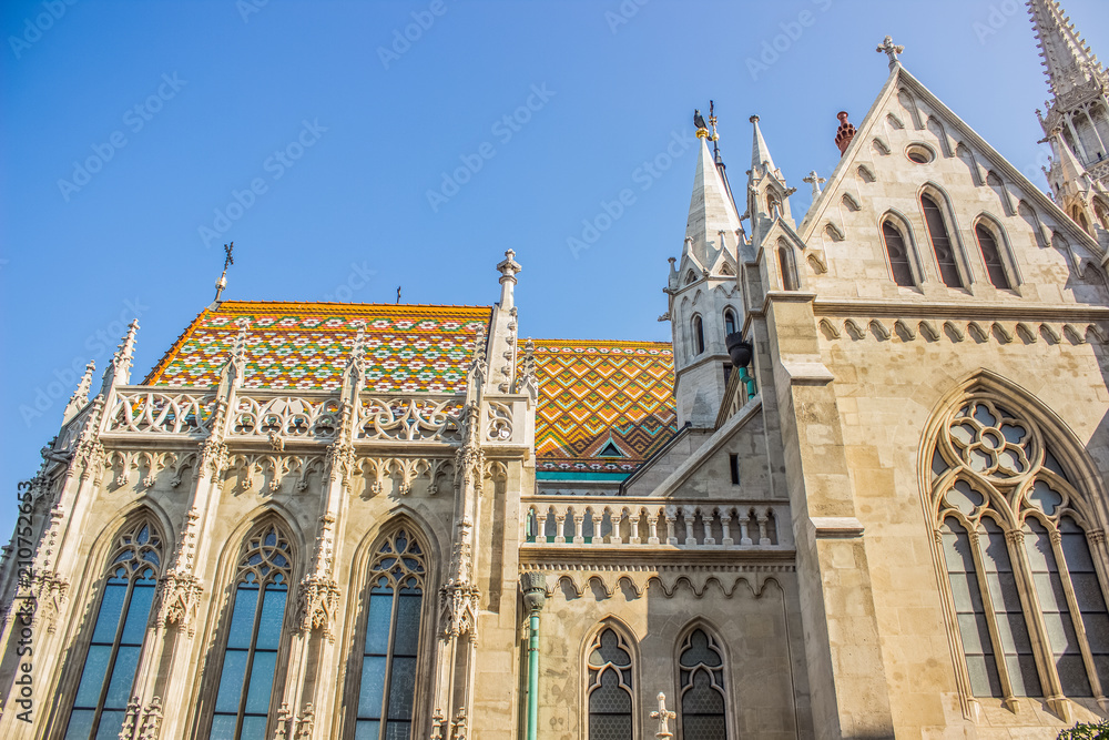 white gothic church medieval building facade on blue sky background in summer time bright colorful day