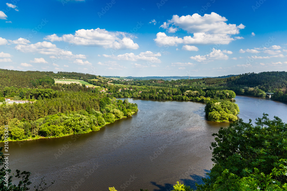 Vltava river in deciduous forest, aerial view, summer day.